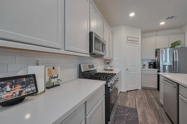 a kitchen with a refrigerator a stove top oven a sink and dishwasher