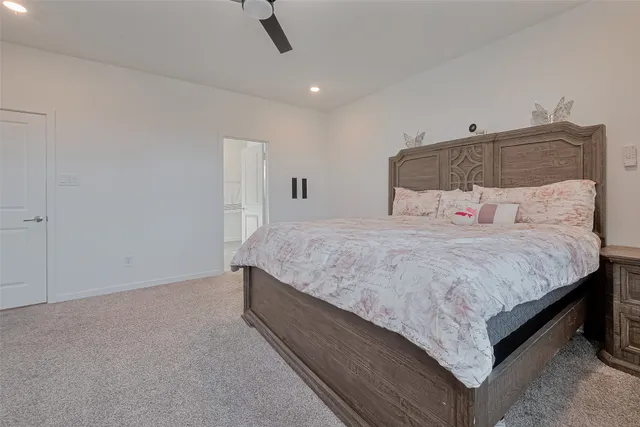 a bedroom with a bed and a ceiling fan