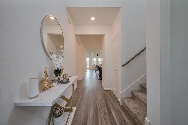 a view of entryway and hall with wooden floor