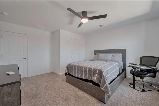 a bedroom with a bed and dresser