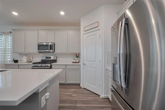 a kitchen with cabinets and stainless steel appliances