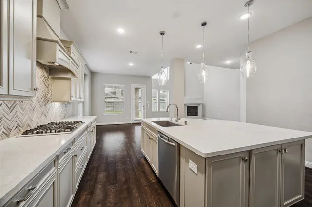 a kitchen with a sink a stove and a refrigerator