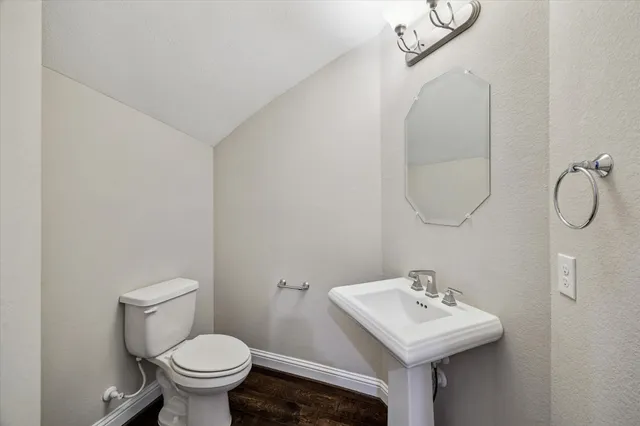 a bathroom with a sink toilet and a mirror