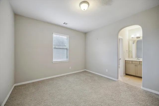 an empty room with a window and bathroom