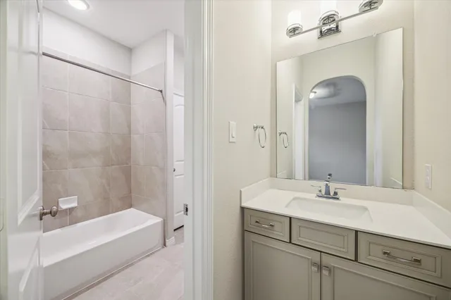 a bathroom with a bathtub a sink and a mirror