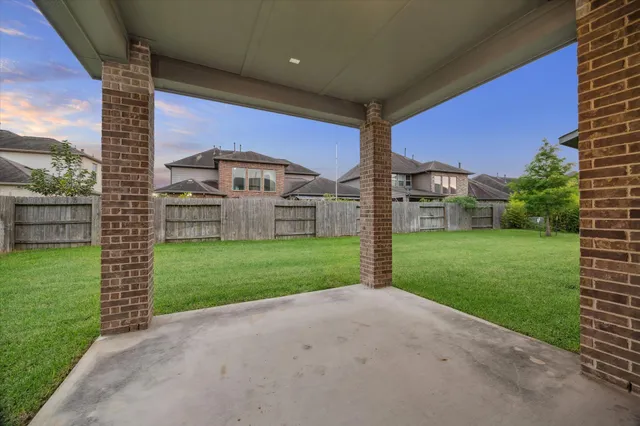 a view of a house with a big yard and a large tree