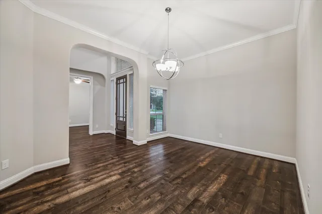 a view of a room with wooden floor and white walls