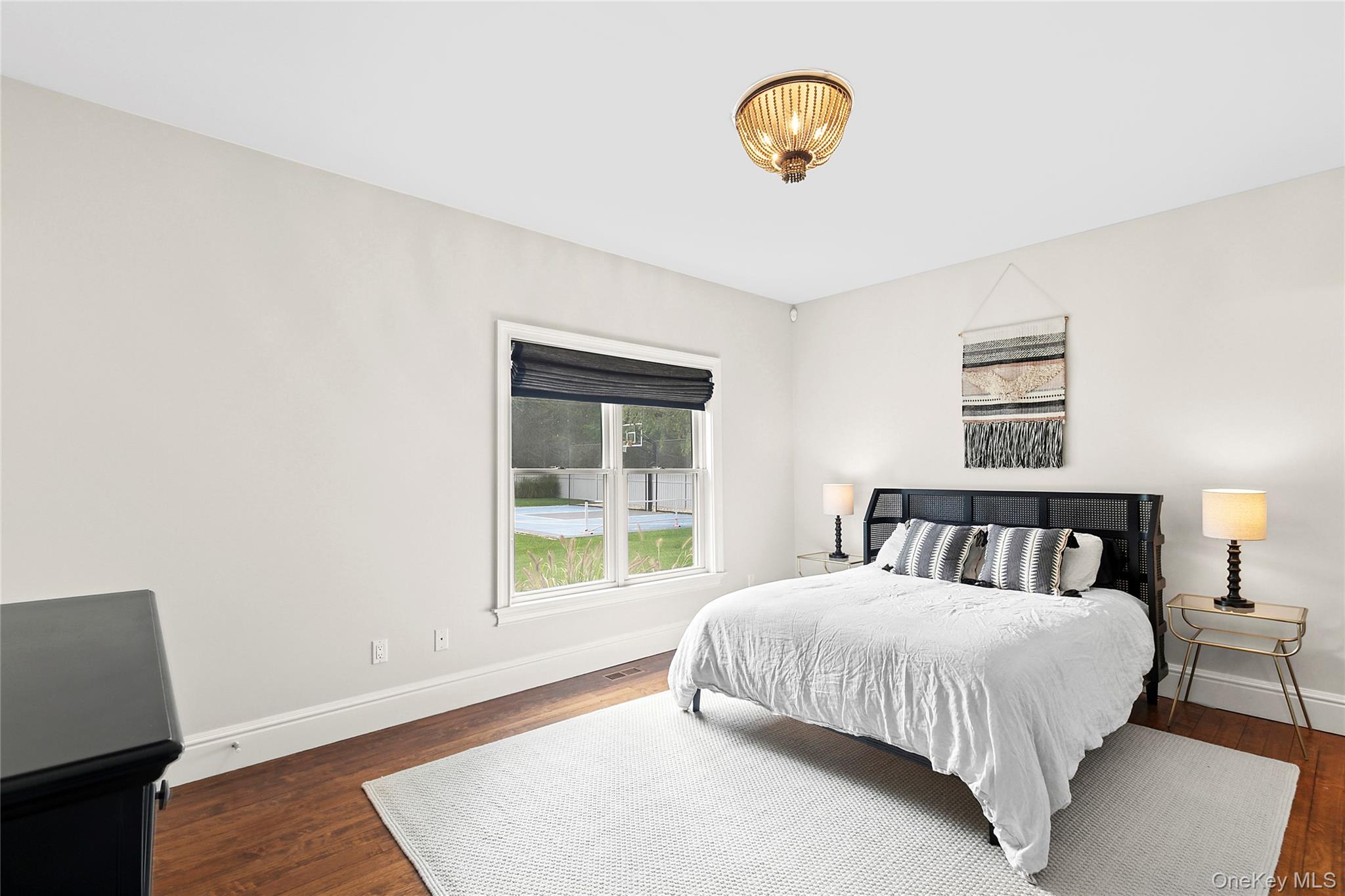 3470 North Bayview Road Southold, NY 11971 - Photo 8 of 25 Bedroom en suite with wood flooring and