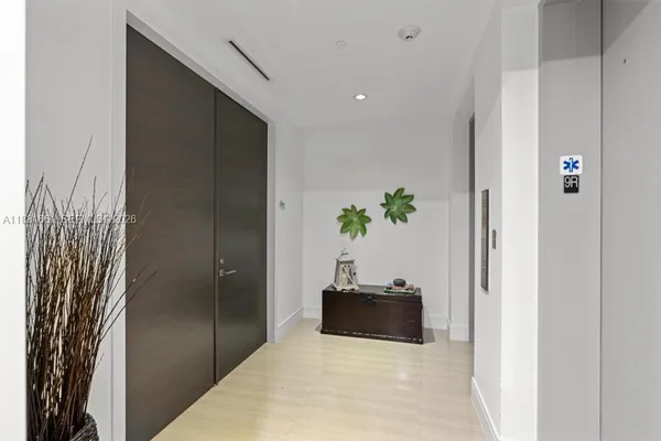 a large kitchen with a large window and stainless steel appliances