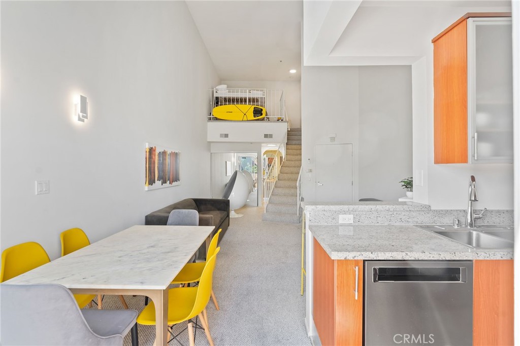 620 South Gramercy Place, Unit 412 Los Angeles, CA 90010 - Photo 11 of 41 a view of a kitchen area with furniture and wooden floor