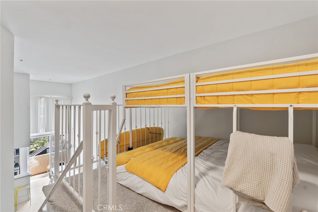 620 South Gramercy Place, Unit 412 Los Angeles, CA 90010 - Photo 16 of 41 a bedroom with a bed and a window