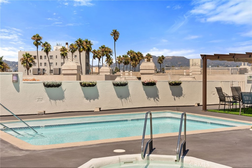 620 South Gramercy Place, Unit 412 Los Angeles, CA 90010 - Photo 28 of 41 a view of a swimming pool with outdoor seating
