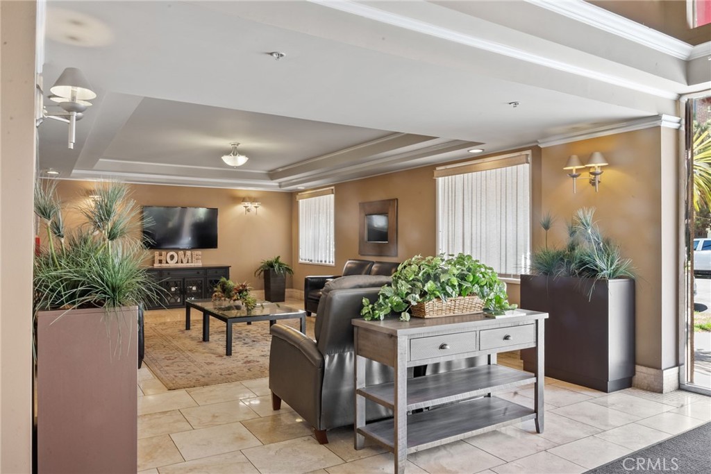 620 South Gramercy Place, Unit 412 Los Angeles, CA 90010 - Photo 30 of 41 a living room with furniture and a flat screen tv