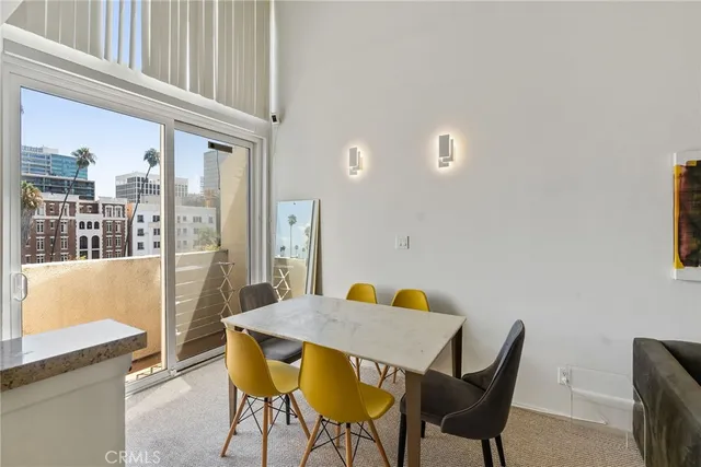 a view of a dining room with furniture and a window