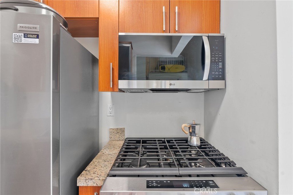 620 South Gramercy Place, Unit 412 Los Angeles, CA 90010 - Photo 9 of 41 a stove top oven sitting inside of a kitchen