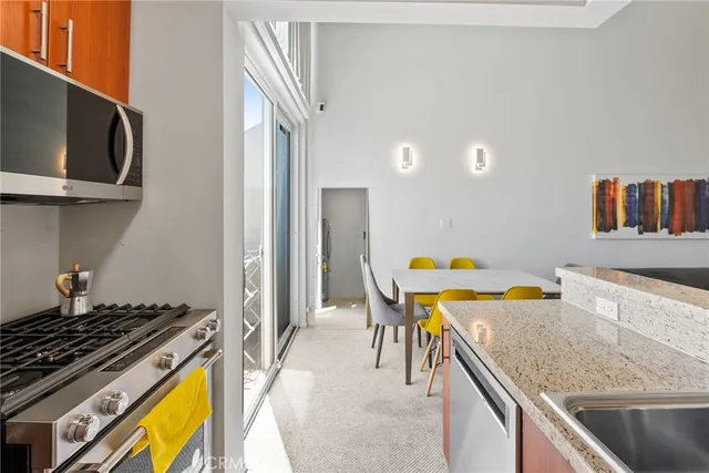 a view of a kitchen area with furniture and wooden floor