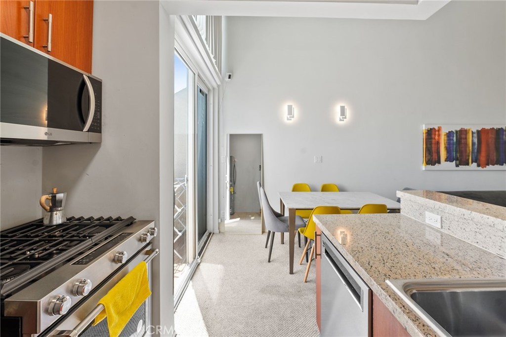 620 South Gramercy Place, Unit 412 Los Angeles, CA 90010 - Photo 10 of 41 a kitchen with a stove and a refrigerator