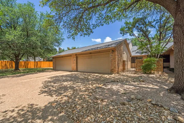 a view of a house with a yard and garage