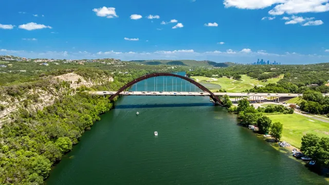 a roof deck with table and chairs under an umbrella