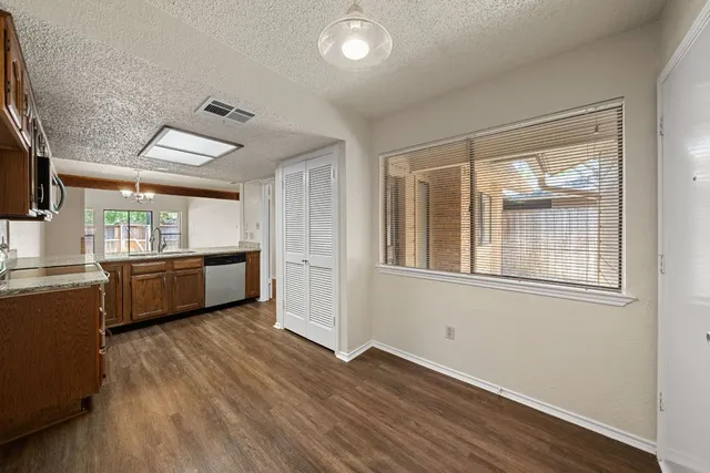 a view of a kitchen with a sink wooden floor and a window