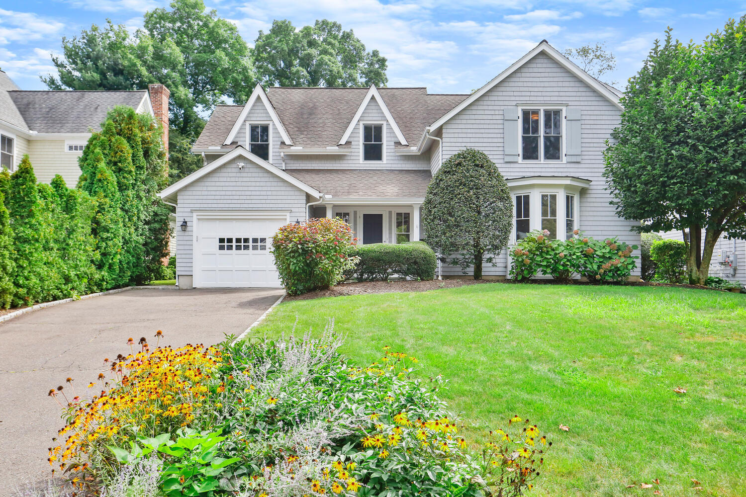 a front view of a house with garden