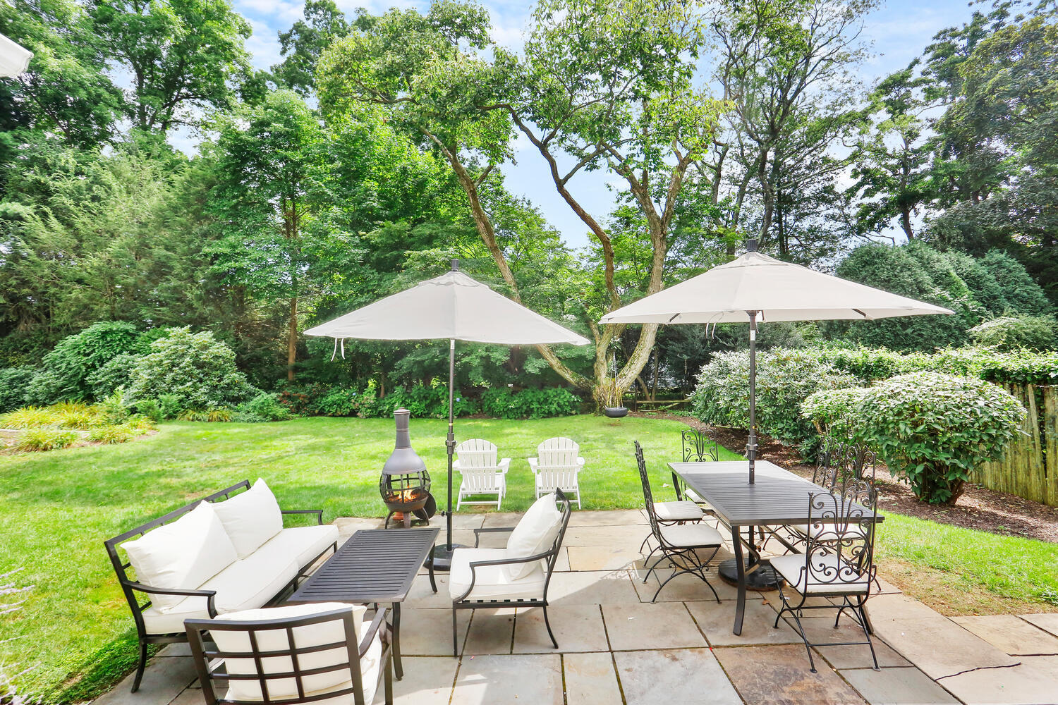 12 Ridgewood Road Rowayton, CT 06853 - Photo 29 of 35 a view of patio with table and chairs under an umbrella