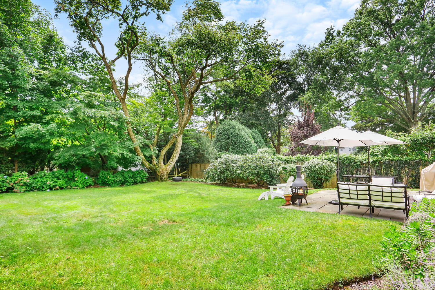 12 Ridgewood Road Rowayton, CT 06853 - Photo 30 of 35 a view of a chair and table under an umbrella