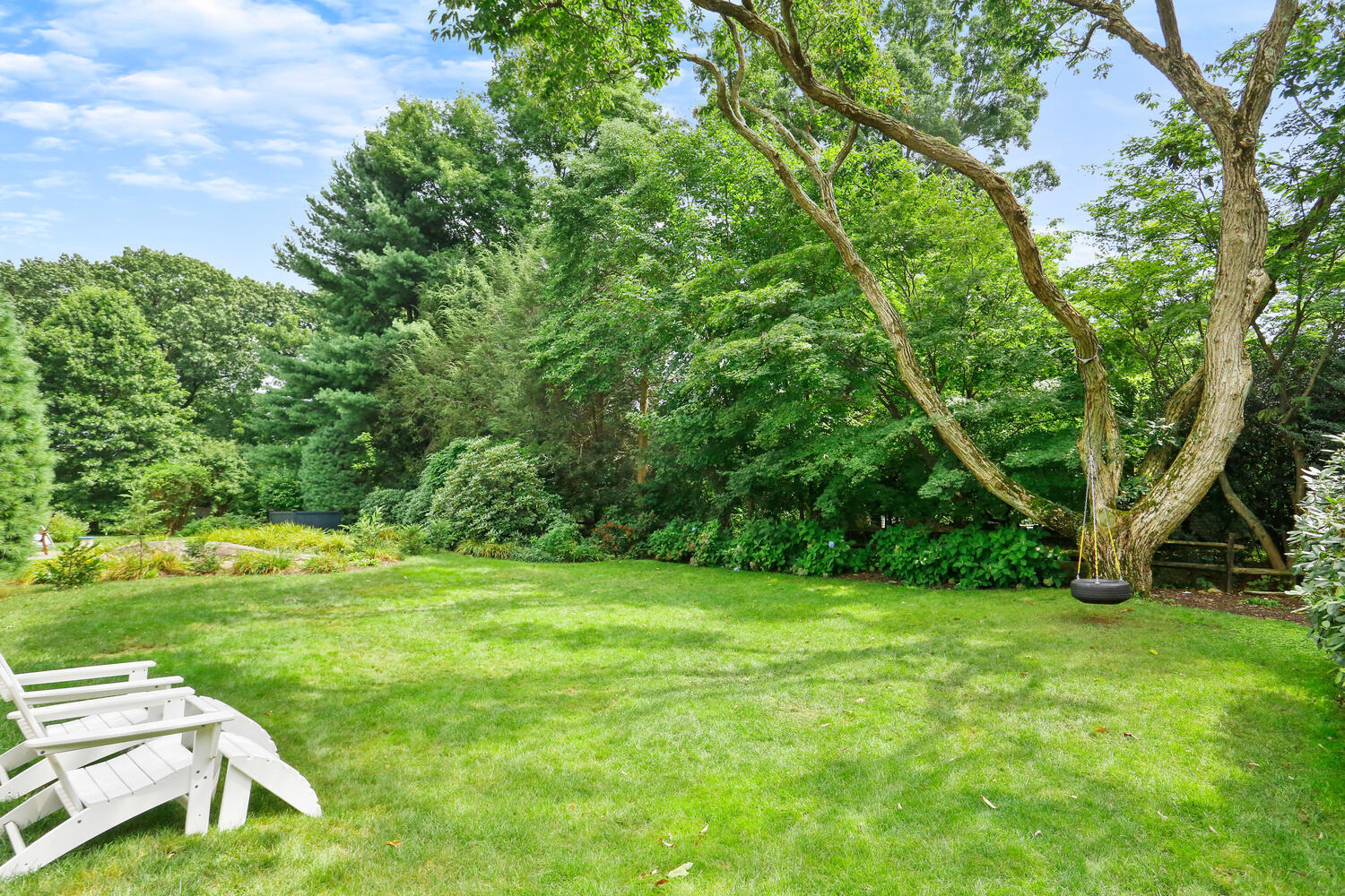 12 Ridgewood Road Rowayton, CT 06853 - Photo 31 of 35 a view of a grassy field with trees in the background