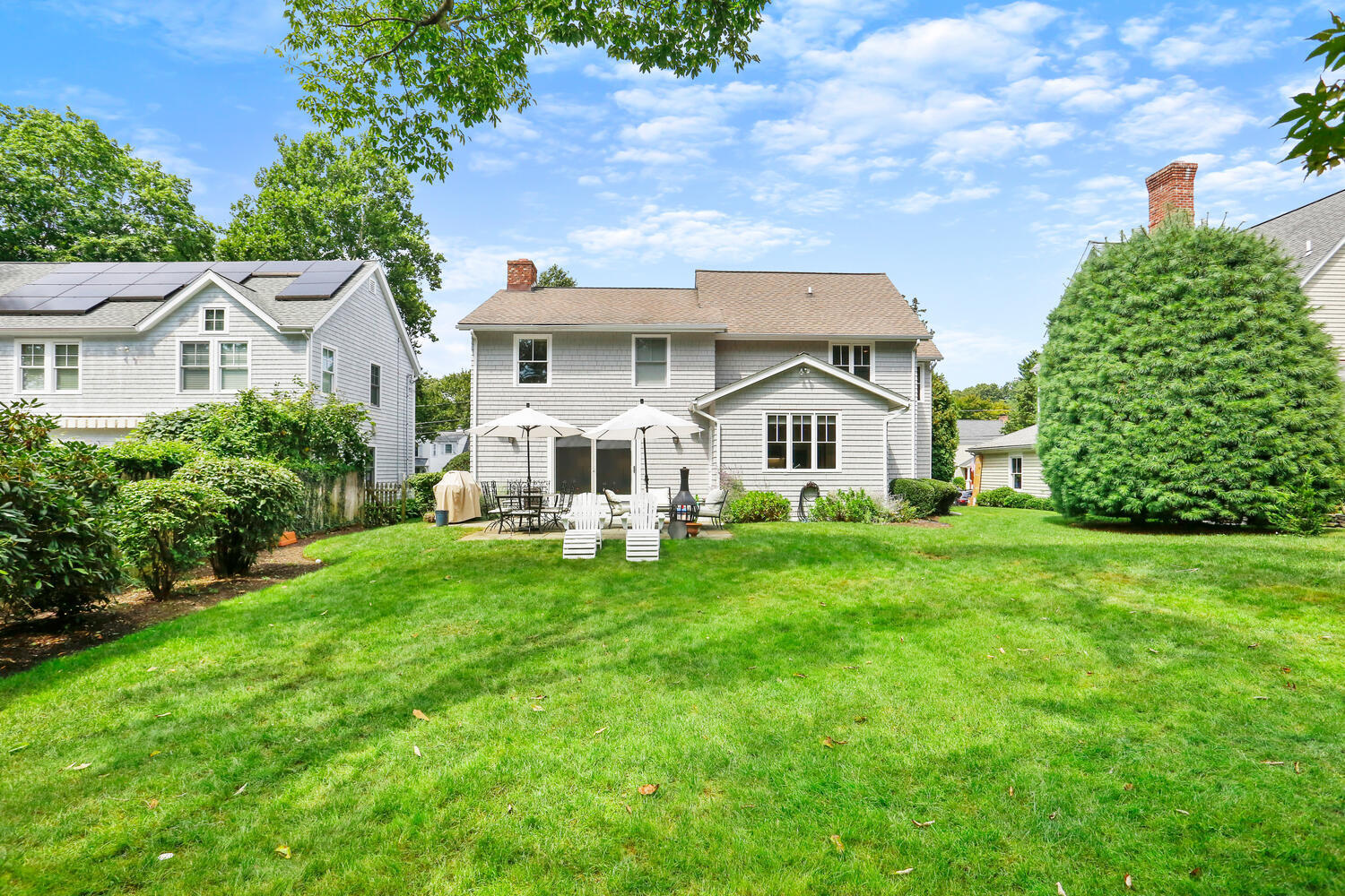 12 Ridgewood Road Rowayton, CT 06853 - Photo 32 of 35 a view of a white house in front of a big yard with large trees