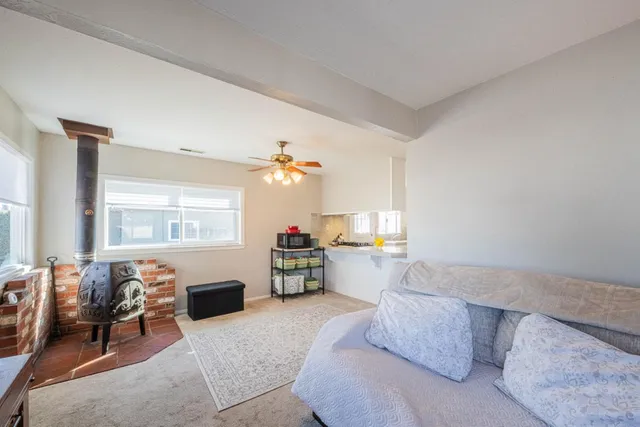 a living room with furniture a fireplace and a window