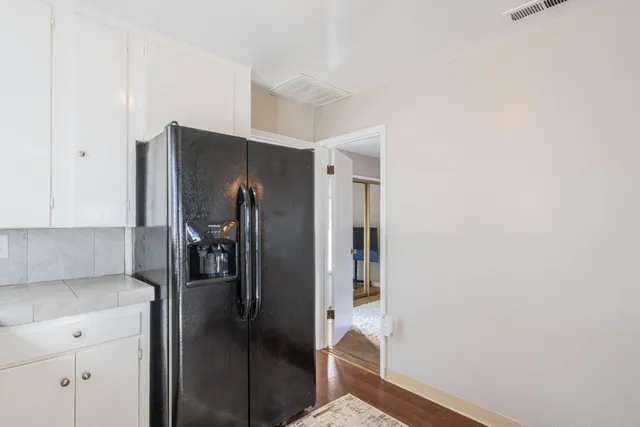 a kitchen with a refrigerator and cabinets