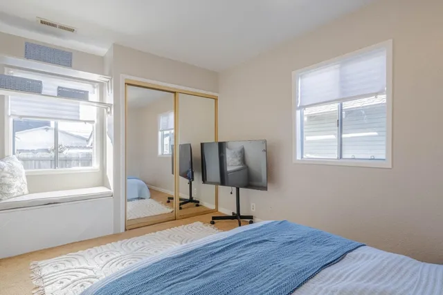 a view of a room with wooden floor and furniture