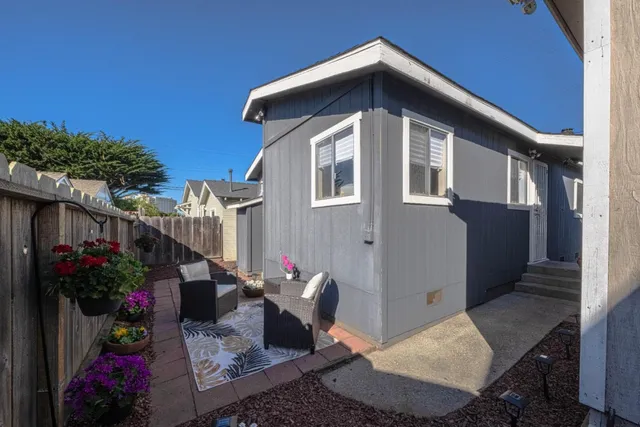 a front view of a house with plants