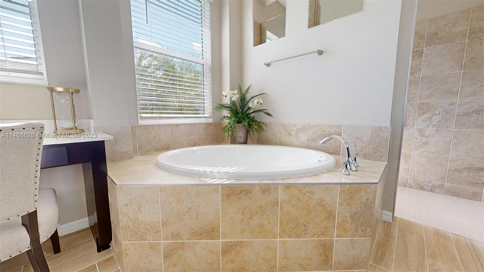 Ave Maria Immokalee, FL 34142 - Photo 15 of 64 a bathroom with a granite countertop sink a mirror and a bathtub