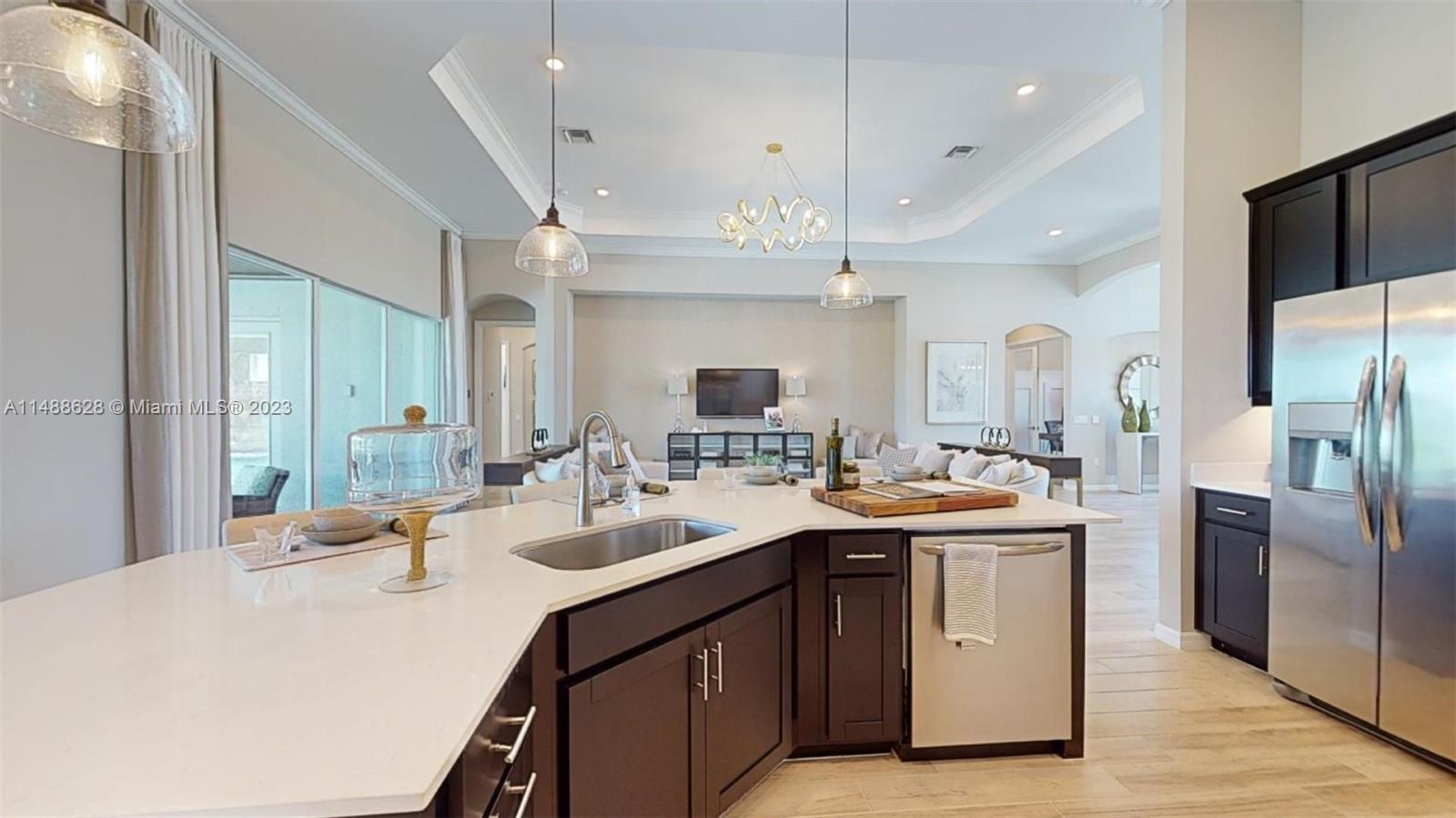 Ave Maria Immokalee, FL 34142 - Photo 33 of 64 a kitchen with a sink a counter top space stainless steel appliances and cabinets