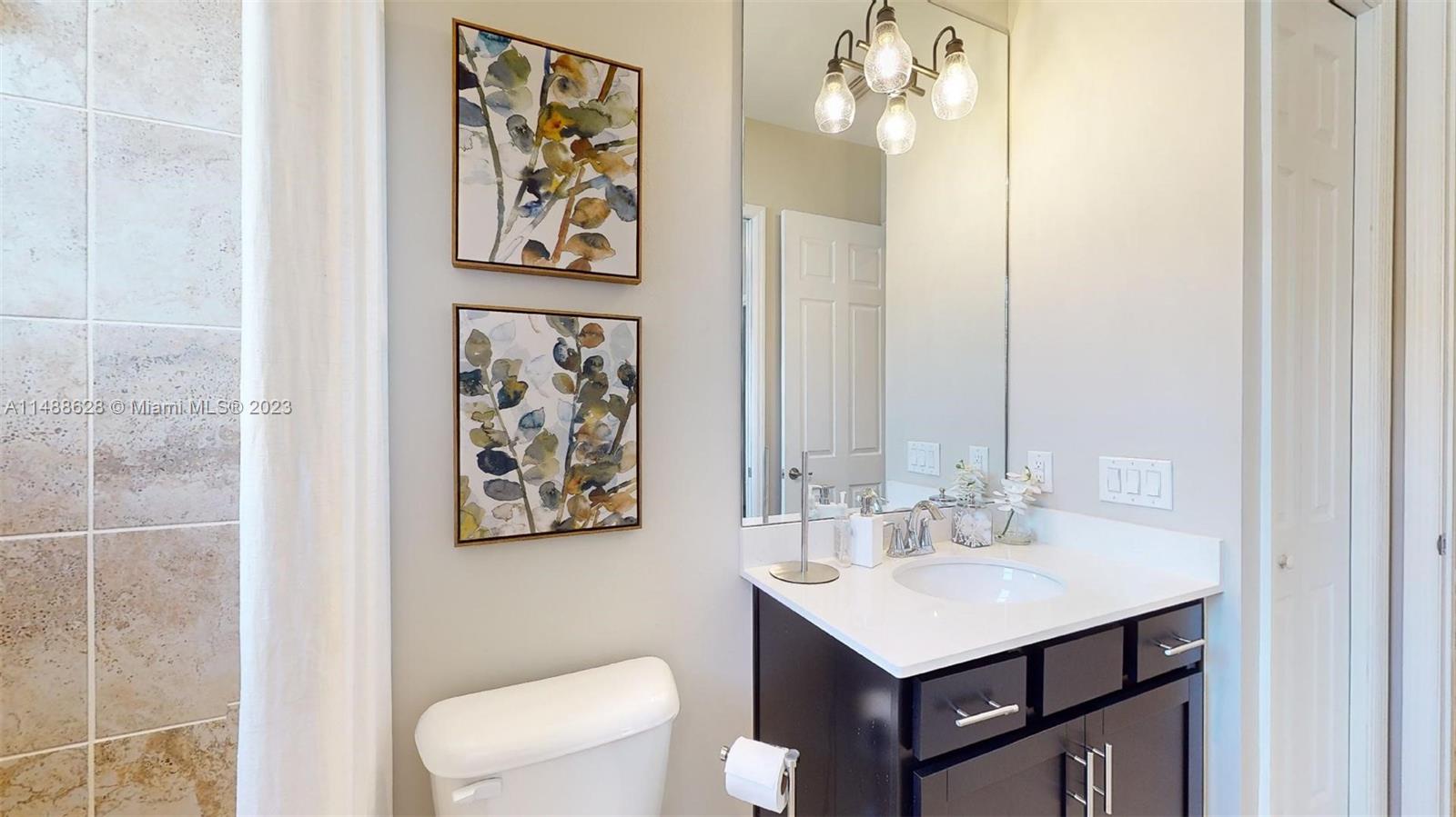 Ave Maria Immokalee, FL 34142 - Photo 47 of 64 a bathroom with a sink vanity and a mirror
