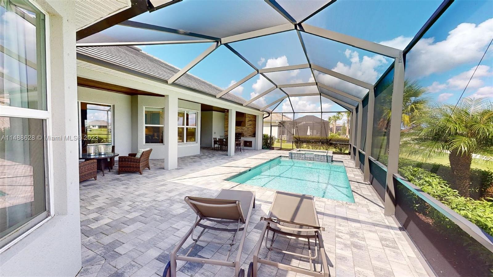 Ave Maria Immokalee, FL 34142 - Photo 56 of 64 a view of a patio with a table and chairs under an umbrella