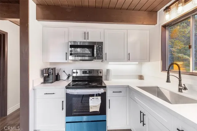 a view of a room with wooden floor and door