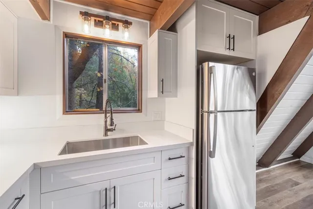 a view of a room with wooden floor and door