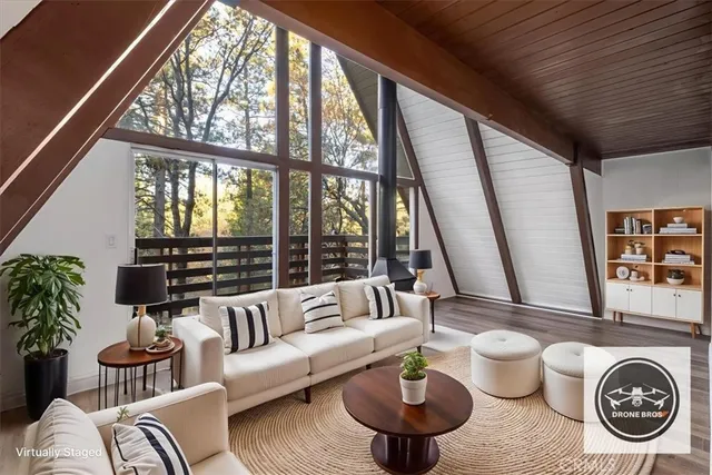 a living room with furniture and a floor to ceiling window