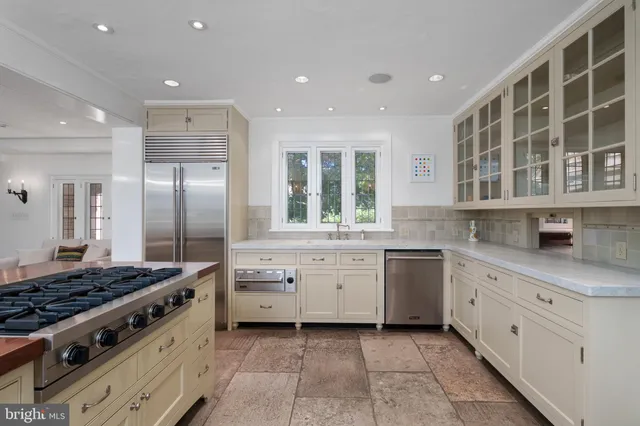 a kitchen with stainless steel appliances granite countertop a sink and a stove