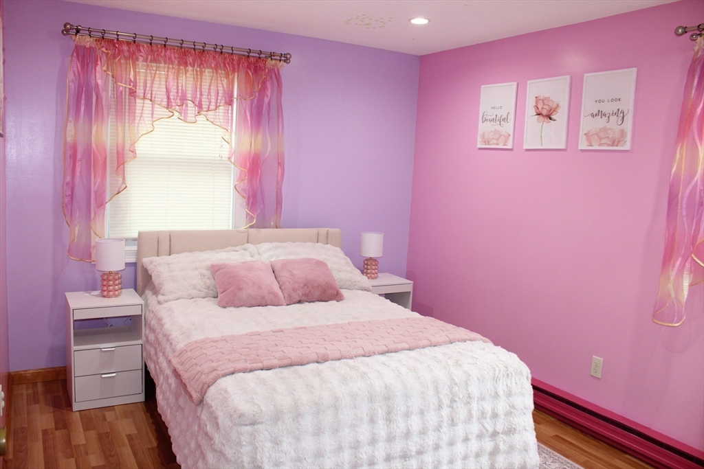 28 State Street Chicopee, MA 01013 - Photo 15 of 25 a bedroom with a bed and a chandelier