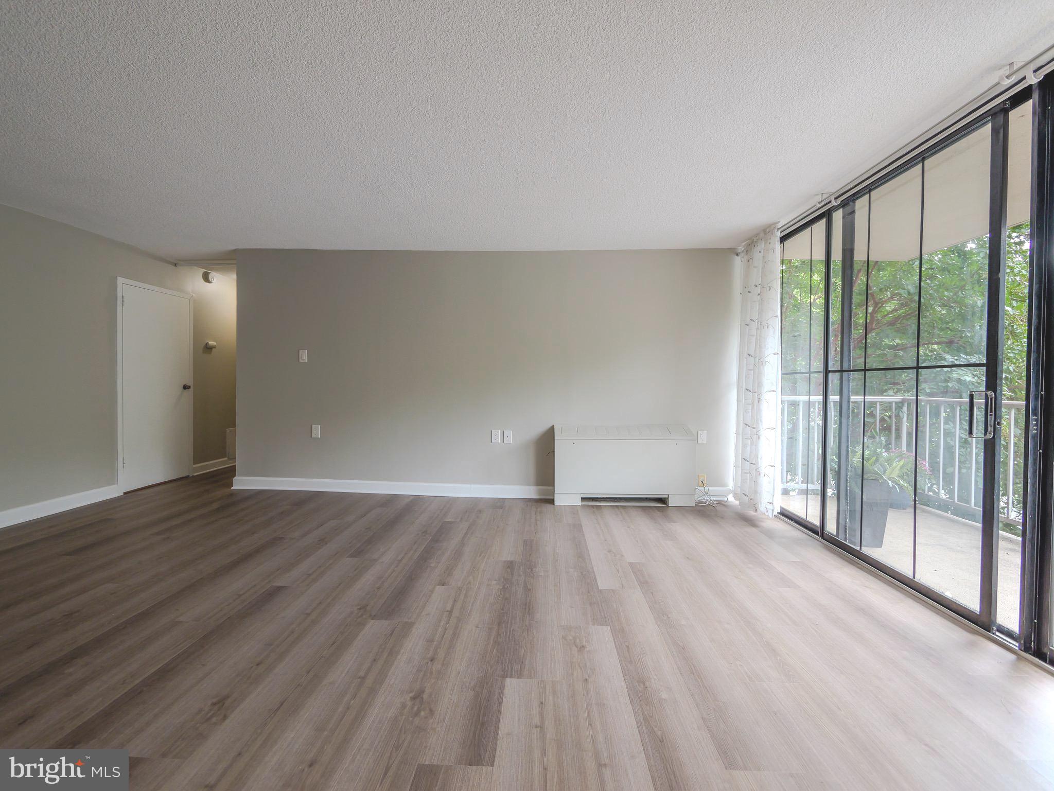 801 Yale Avenue, Unit 107 Swarthmore, PA 19081 - Photo 16 of 35 a view of an empty room with wooden floor and a window