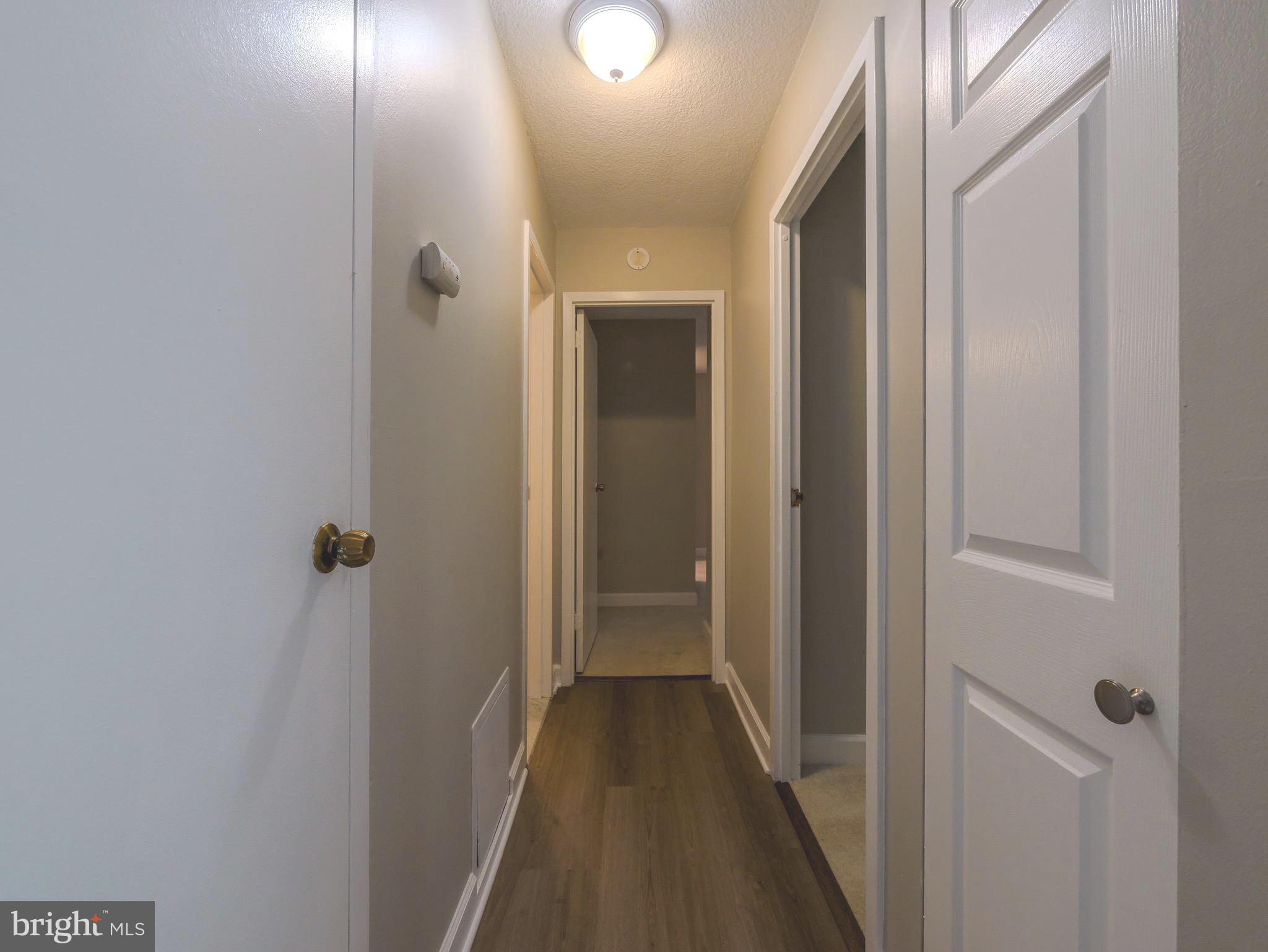 801 Yale Avenue, Unit 107 Swarthmore, PA 19081 - Photo 19 of 35 a view of a hallway with wooden floor