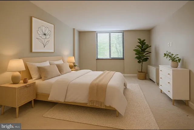 a bedroom with a large bed and a potted plant