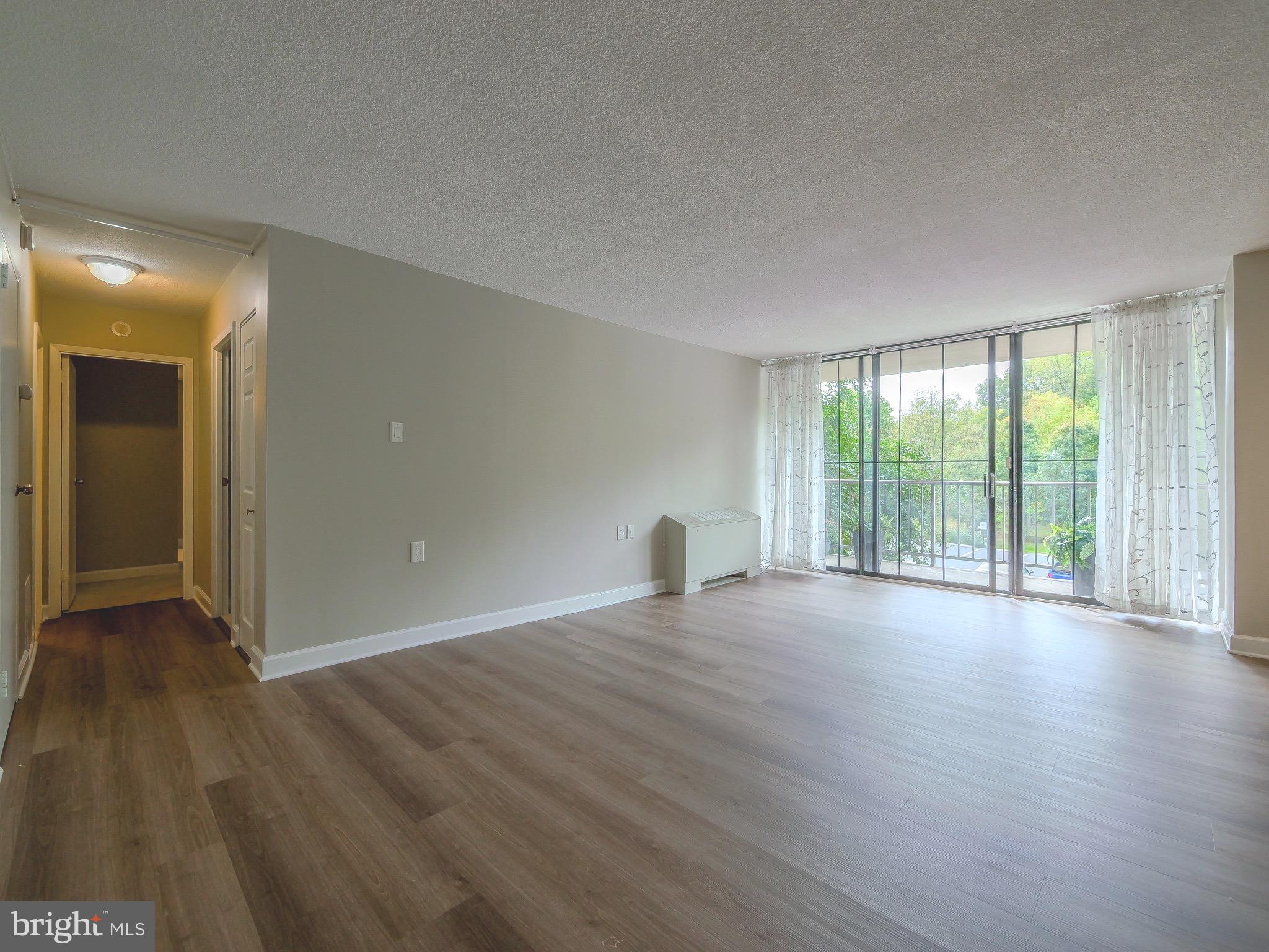 801 Yale Avenue, Unit 107 Swarthmore, PA 19081 - Photo 9 of 35 wooden floor in an empty room with a window
