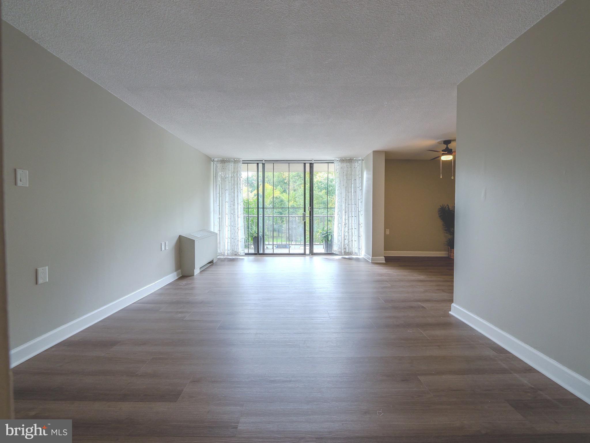 801 Yale Avenue, Unit 107 Swarthmore, PA 19081 - Photo 10 of 35 a view of an empty room with wooden floor and a window