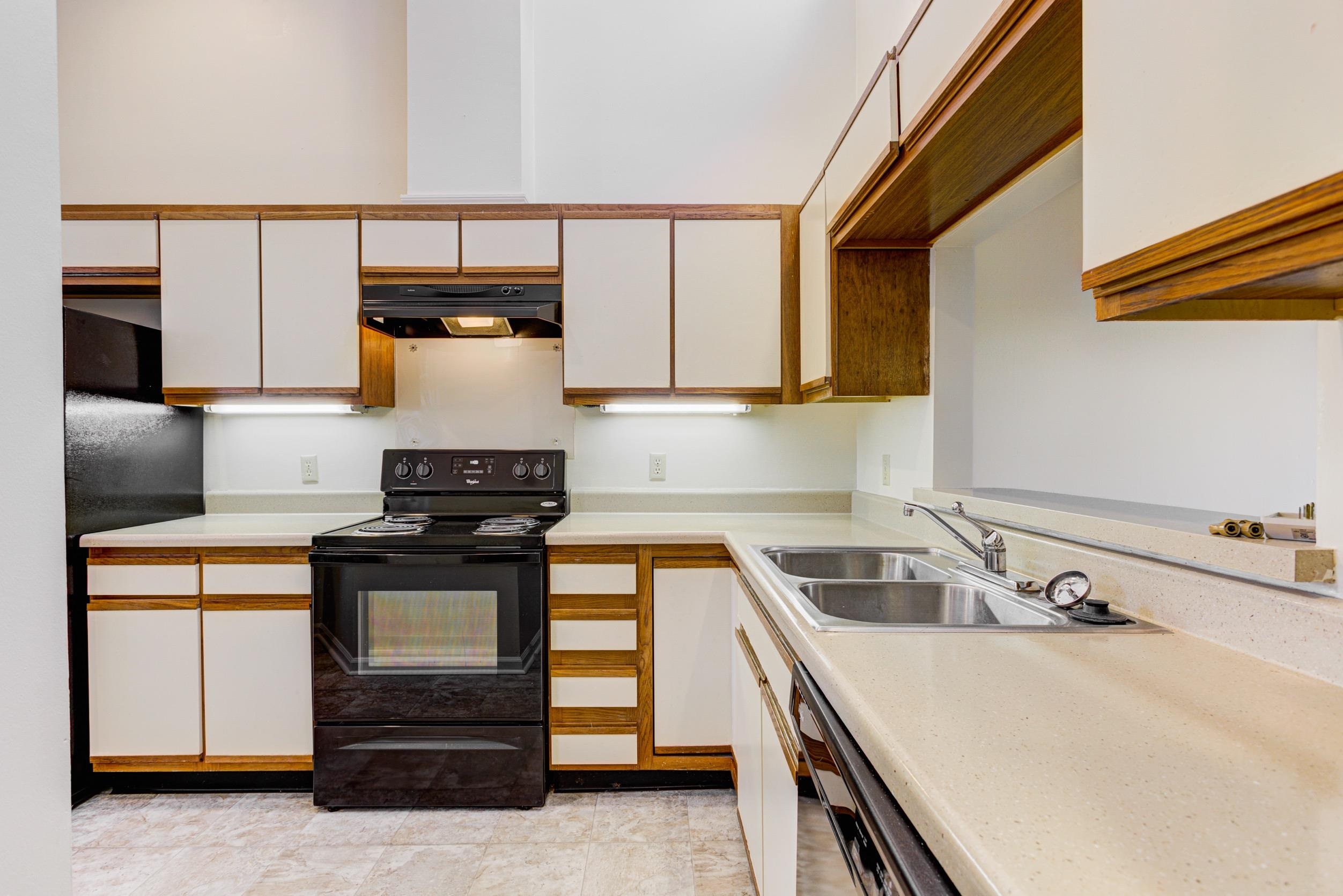 5013 Scheibler Road, Unit C1 Memphis, TN 38128 - Photo 5 of 36 Kitchen featuring black appliances, light countertops, brown cabinetry, and white cabinetry