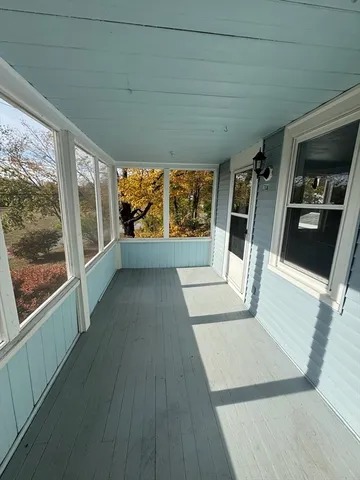 a view of an entryway with wooden floor