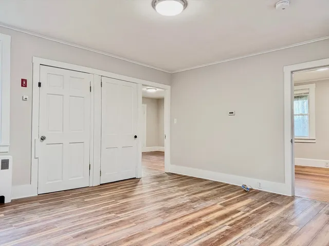 a view of a room with wooden floor